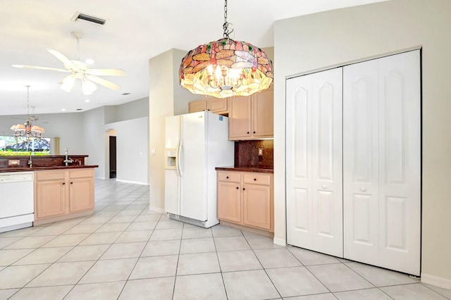 kitchen featuring tasteful backsplash, light brown cabinetry, white appliances, and decorative light fixtures