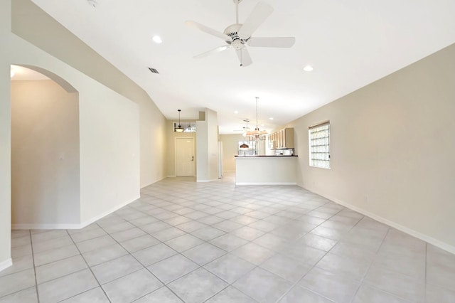 unfurnished room with ceiling fan with notable chandelier