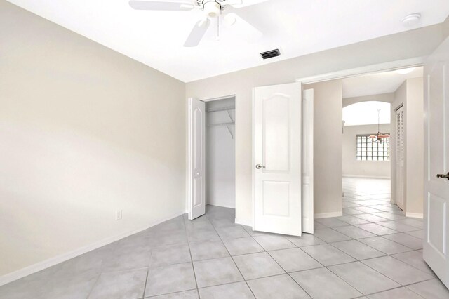 8278 Duomo Cir, Boynton Beach, FL 33472 - unfurnished bedroom featuring light tile patterned floors, baseboards, a closet, a ceiling fan, and a chandelier