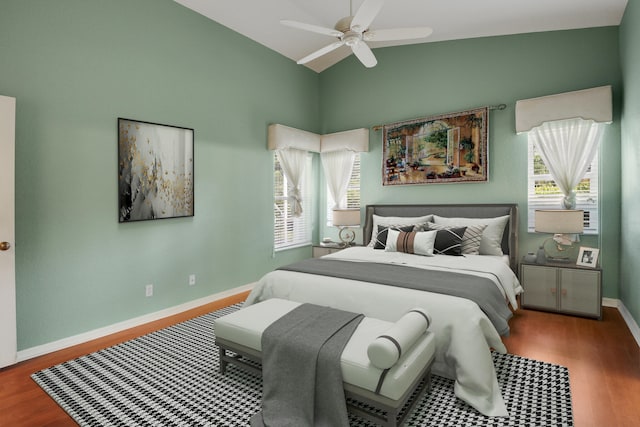 bedroom featuring hardwood / wood-style floors, ceiling fan, and vaulted ceiling