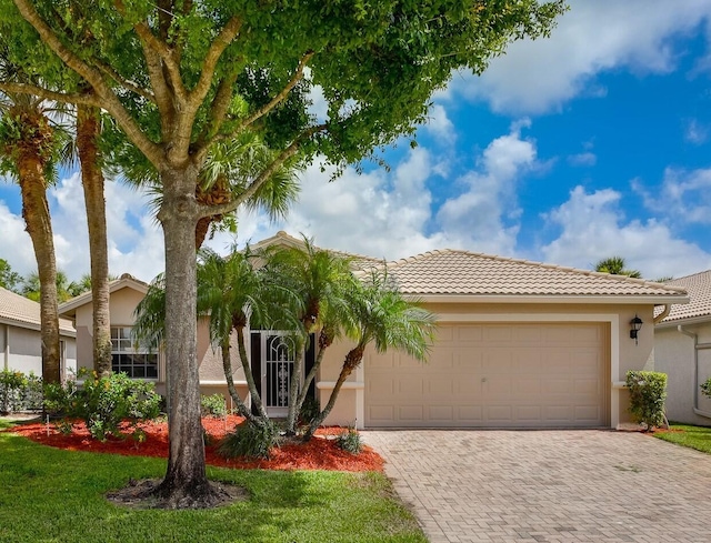 8278 Duomo Cir, Boynton Beach, FL 33472 - view of front of property with decorative driveway, stucco siding, an attached garage, and a tile roof