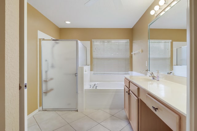 bathroom featuring tile patterned floors, vanity, and shower with separate bathtub