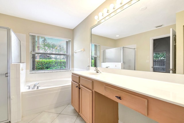 bathroom featuring plus walk in shower, tile patterned floors, and vanity