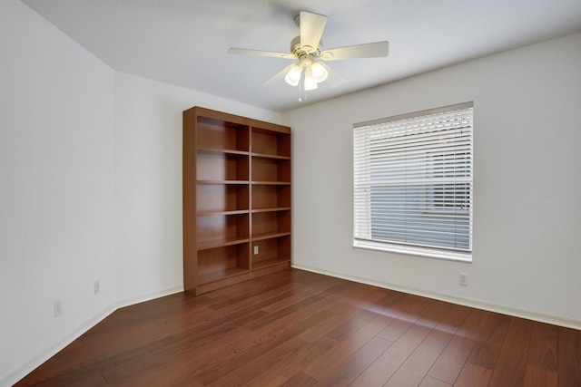 spare room with dark hardwood / wood-style floors and ceiling fan