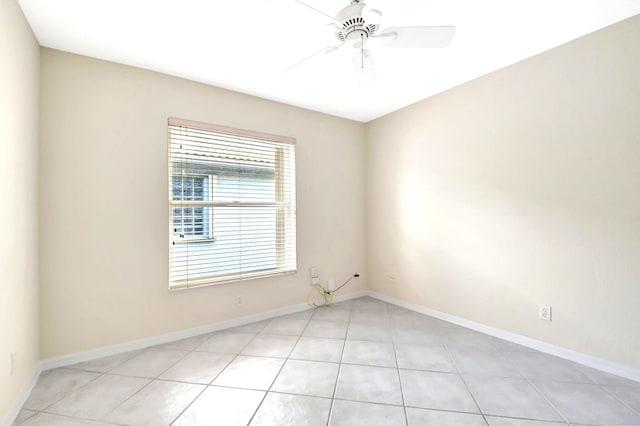 empty room featuring light tile patterned floors and ceiling fan