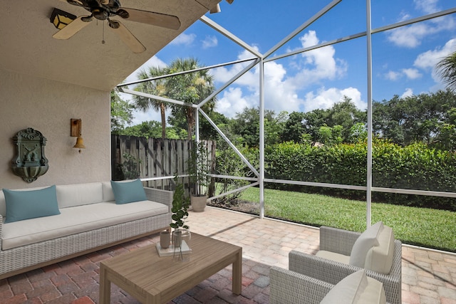 sunroom / solarium featuring ceiling fan