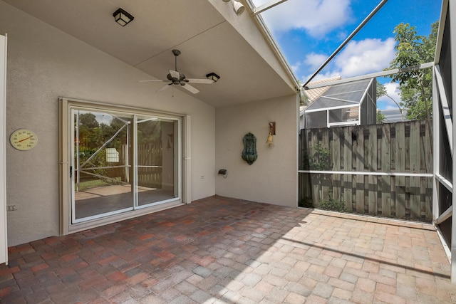 view of patio featuring ceiling fan and a lanai