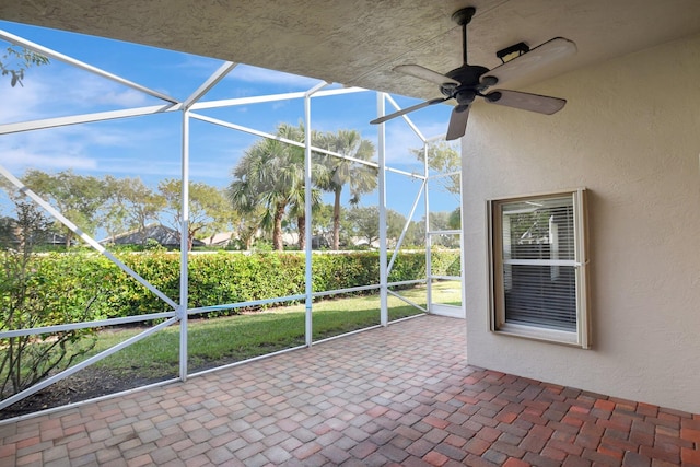 unfurnished sunroom with ceiling fan