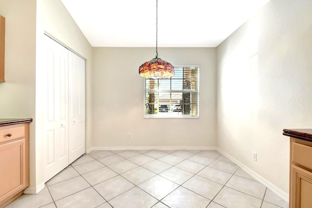 unfurnished dining area with light tile patterned flooring