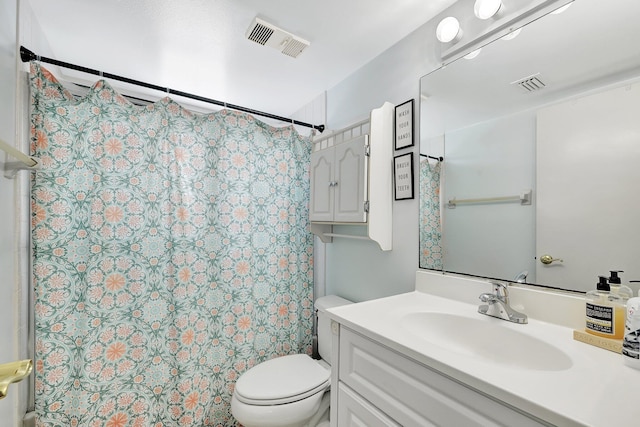 bathroom featuring vanity, curtained shower, and toilet