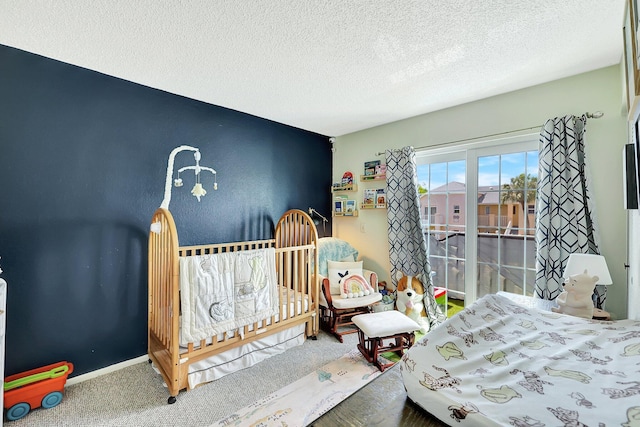 carpeted bedroom featuring a textured ceiling