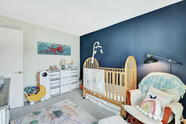 carpeted bedroom with a nursery area