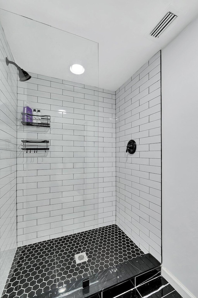 bathroom with tiled shower