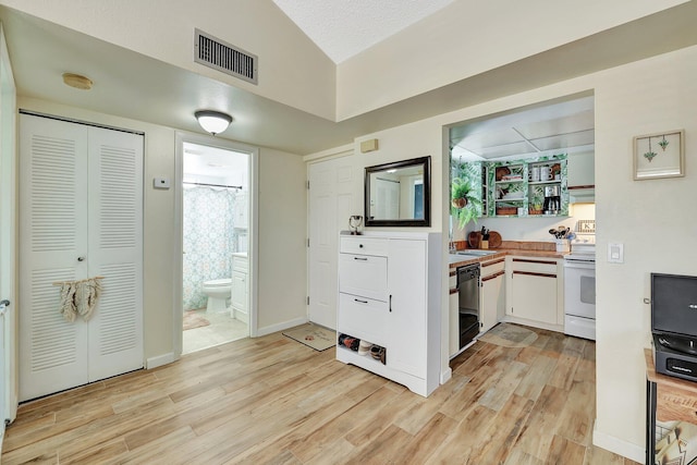 kitchen featuring white cabinetry, white range with electric stovetop, light wood-type flooring, and black dishwasher