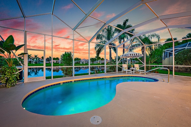 pool at dusk with a patio, a lanai, and a water view