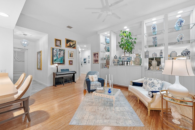 sitting room with light hardwood / wood-style flooring and ceiling fan