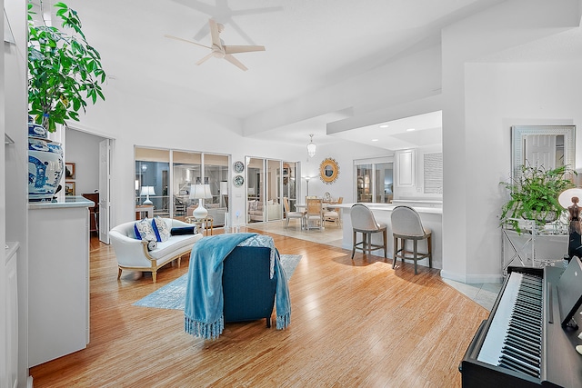 living room with light hardwood / wood-style floors and ceiling fan