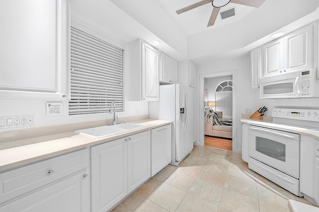 kitchen featuring white appliances, light tile patterned flooring, sink, white cabinetry, and ceiling fan