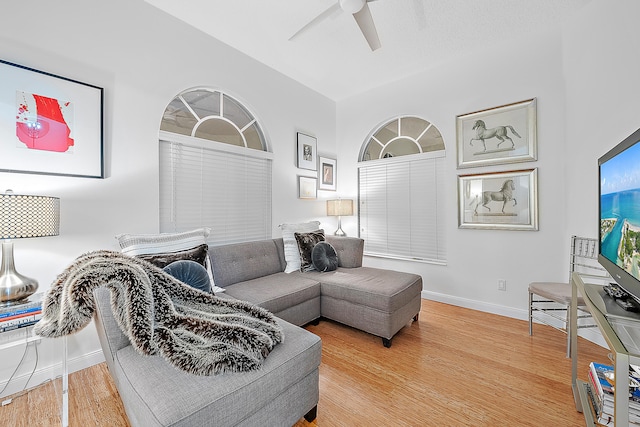 living room featuring ceiling fan and hardwood / wood-style floors