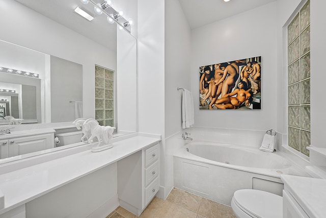 bathroom with vanity, a tub, toilet, and tile patterned flooring