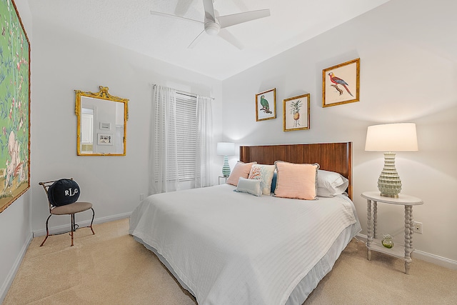 bedroom with ceiling fan and light colored carpet