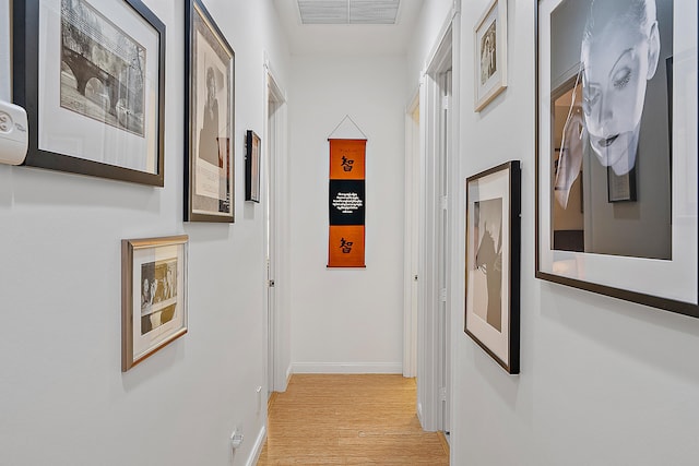 corridor with light hardwood / wood-style floors