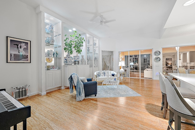 living room with light wood-type flooring and ceiling fan