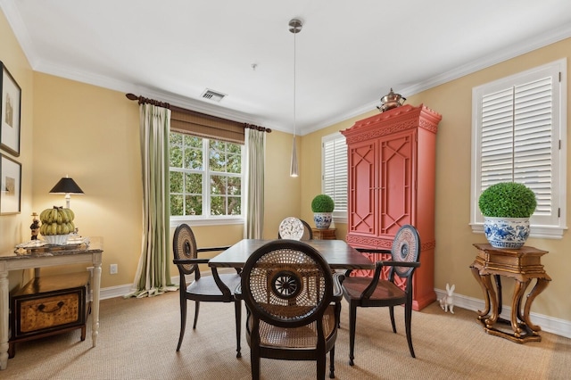 carpeted dining area with crown molding