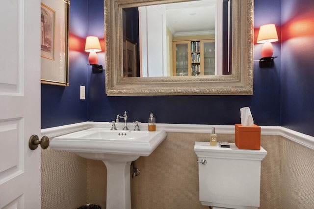 bathroom with toilet and crown molding