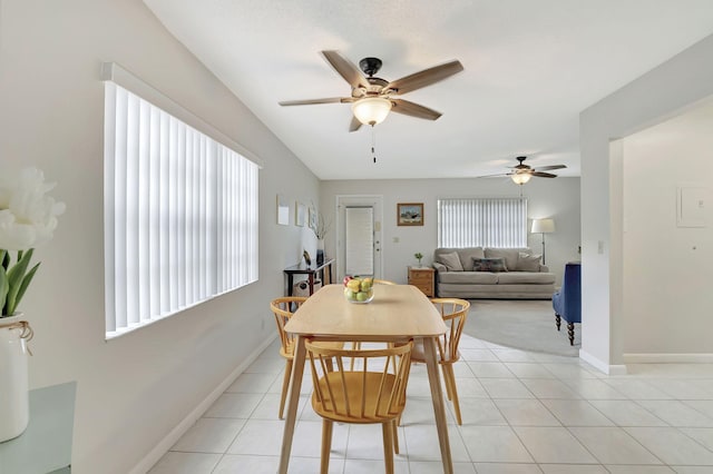 tiled dining room featuring ceiling fan