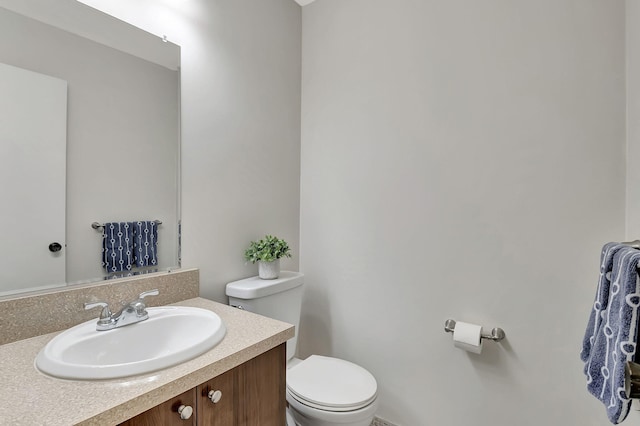 bathroom featuring toilet and vanity