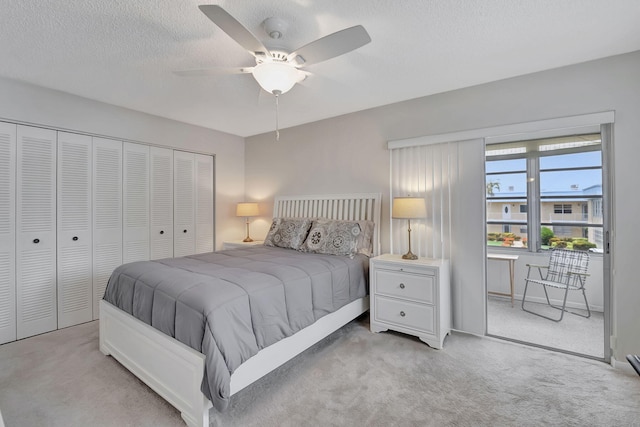 carpeted bedroom featuring a closet, a textured ceiling, and ceiling fan