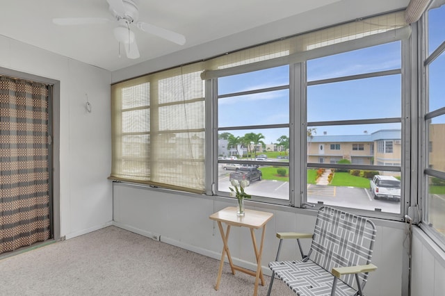 sunroom / solarium featuring ceiling fan