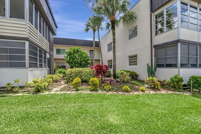 view of home's community with a yard