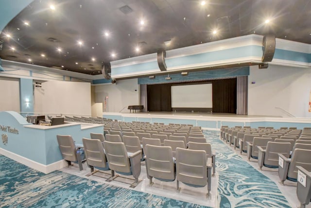 home theater room featuring light colored carpet