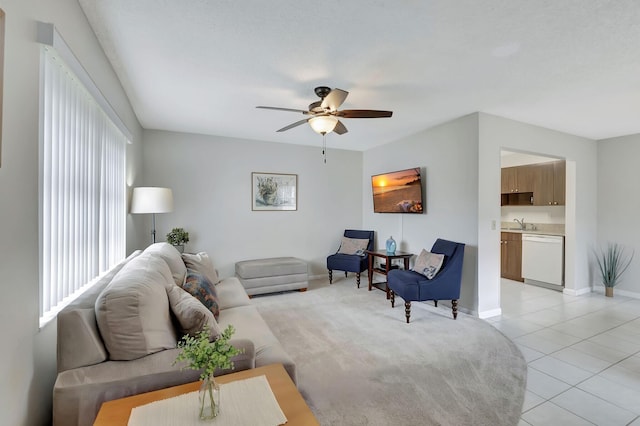 living room with sink, light tile patterned floors, and ceiling fan