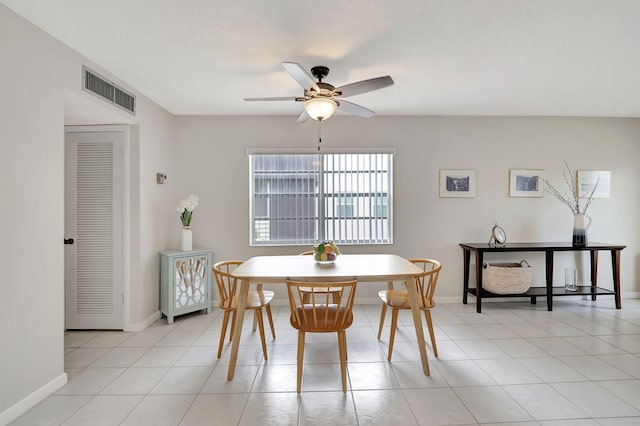 tiled dining room featuring ceiling fan