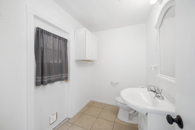 bathroom featuring tile patterned flooring and toilet