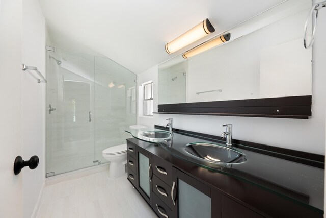 bathroom with tile patterned flooring, walk in shower, double sink vanity, and toilet