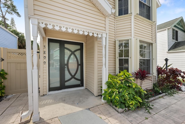 doorway to property featuring fence