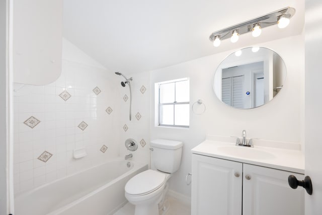 full bathroom with tiled shower / bath combo, vaulted ceiling, toilet, and vanity