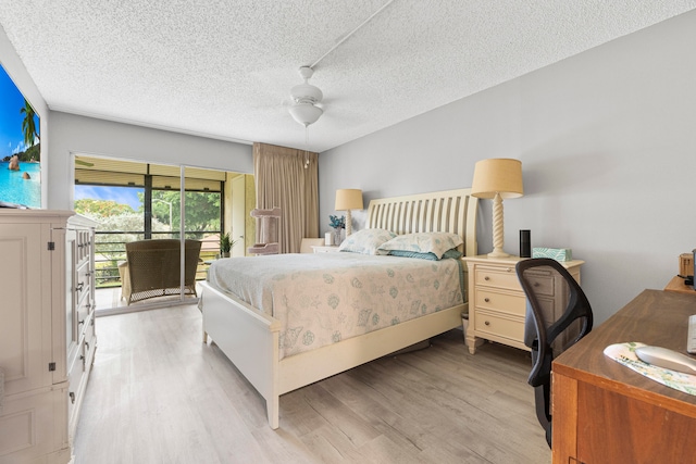 bedroom featuring light hardwood / wood-style flooring, a textured ceiling, ceiling fan, and access to exterior