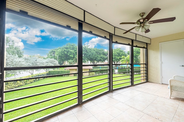 unfurnished sunroom with ceiling fan