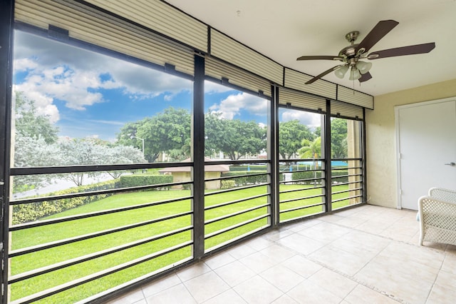 unfurnished sunroom with ceiling fan