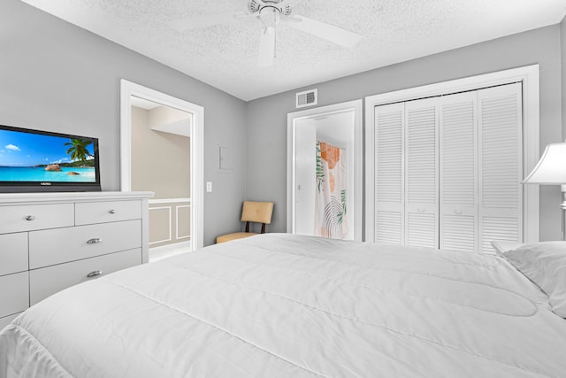 bedroom with a textured ceiling, ceiling fan, and a closet