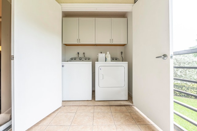 washroom with separate washer and dryer, cabinets, a wealth of natural light, and light tile patterned floors