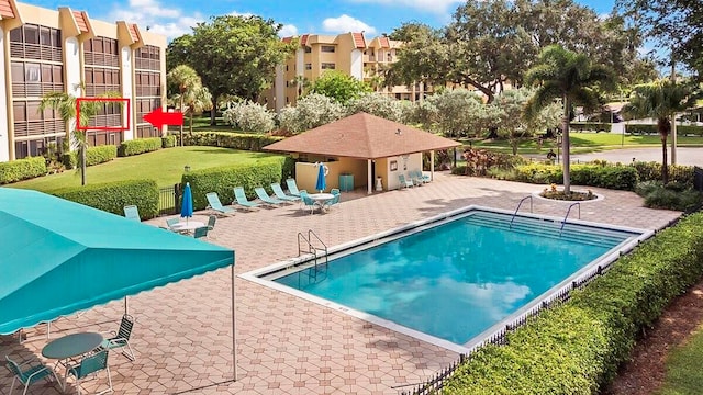 view of swimming pool with a yard and a patio area