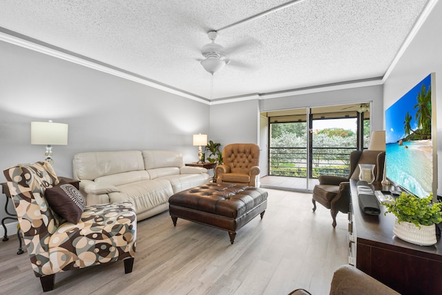 living room featuring crown molding, light wood-type flooring, ceiling fan, and a textured ceiling