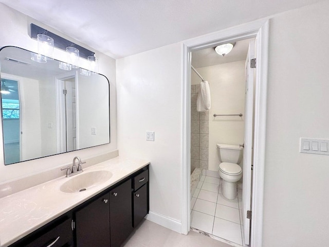 bathroom featuring toilet, walk in shower, tile patterned floors, and vanity