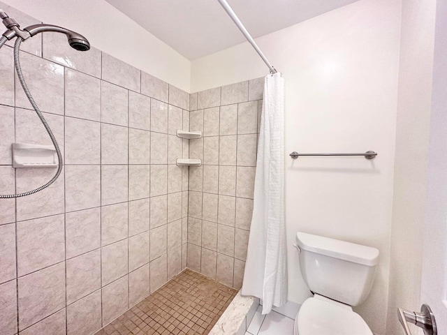 bathroom with tile patterned flooring, toilet, and a shower with shower curtain